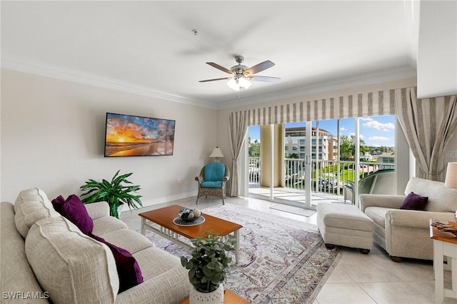 living room featuring light tile patterned floors, ornamental molding, a ceiling fan, and baseboards