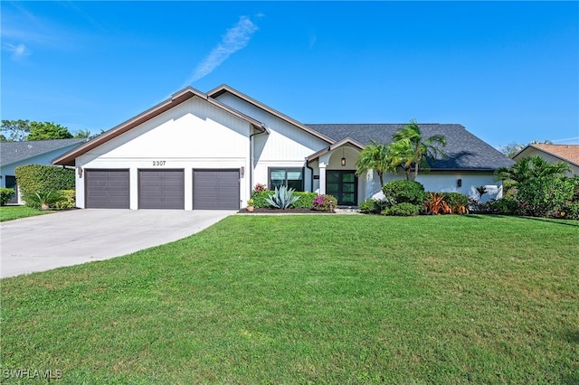 view of front of home with a garage, concrete driveway, and a front yard