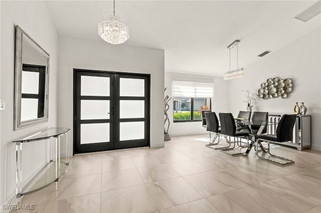 foyer with french doors, visible vents, a notable chandelier, and baseboards