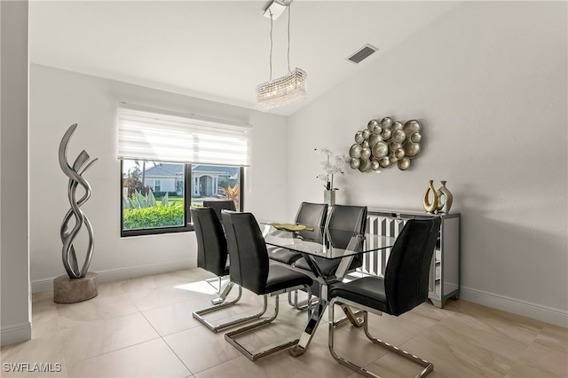 dining area featuring lofted ceiling, baseboards, visible vents, and tile patterned flooring