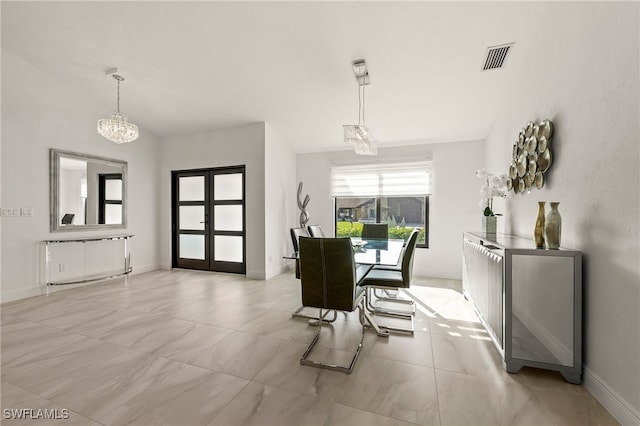 dining space featuring baseboards, vaulted ceiling, visible vents, and a chandelier