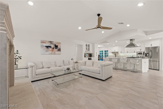 living area featuring vaulted ceiling, recessed lighting, visible vents, and a ceiling fan