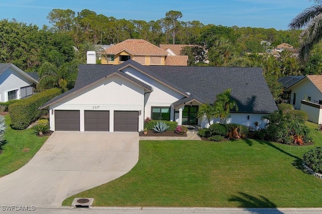 view of front of home featuring a front yard, driveway, and an attached garage