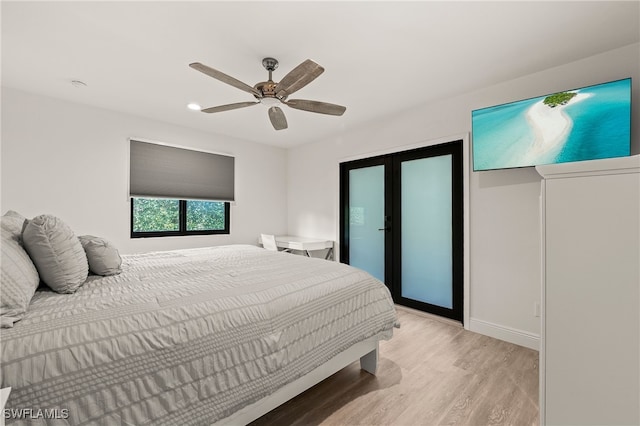 bedroom with light wood-style floors, a ceiling fan, and french doors