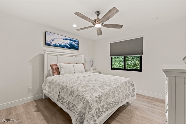 bedroom featuring ceiling fan, recessed lighting, light wood-style flooring, and baseboards