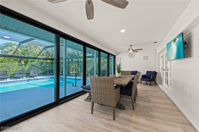 sunroom / solarium featuring ceiling fan, visible vents, and french doors