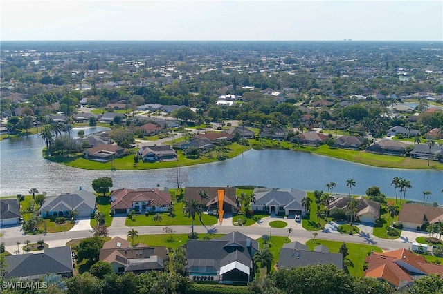 drone / aerial view featuring a water view and a residential view