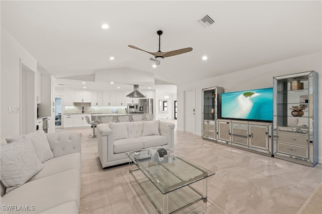 living area with lofted ceiling, ceiling fan, visible vents, and recessed lighting