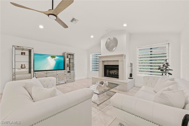 living area with recessed lighting, visible vents, a fireplace with raised hearth, vaulted ceiling, and ceiling fan