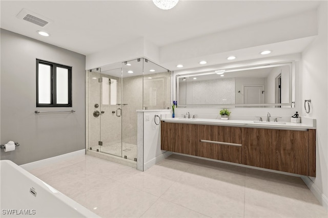 full bath featuring double vanity, visible vents, tile patterned floors, a shower stall, and a sink