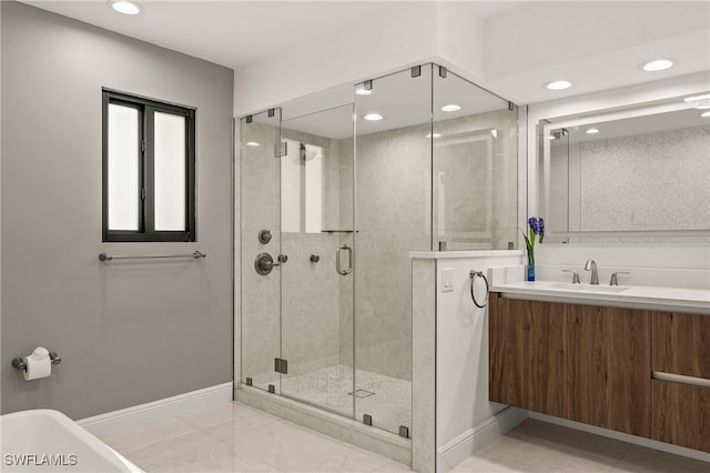 bathroom featuring tile patterned flooring, a shower stall, vanity, and baseboards