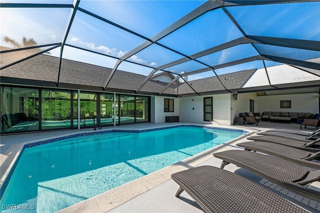 outdoor pool featuring a lanai, a patio area, and an outdoor living space