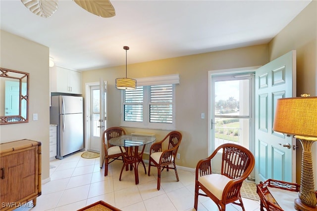 dining area featuring light tile patterned floors and baseboards