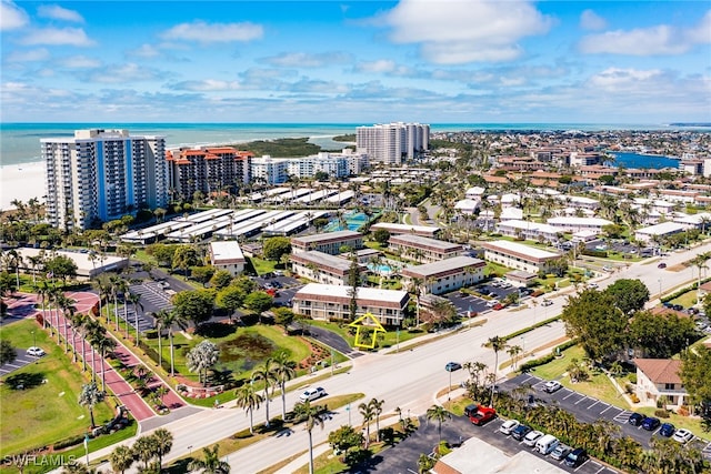 birds eye view of property with a view of city and a water view