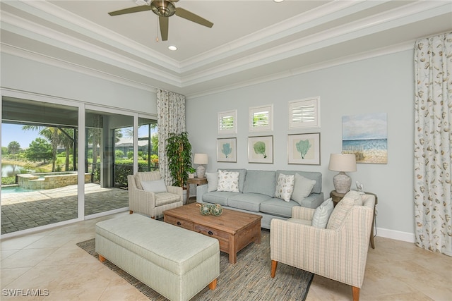 living room featuring light tile patterned floors, ceiling fan, baseboards, ornamental molding, and a raised ceiling