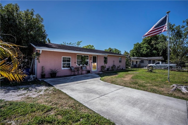 single story home featuring a front lawn and stucco siding