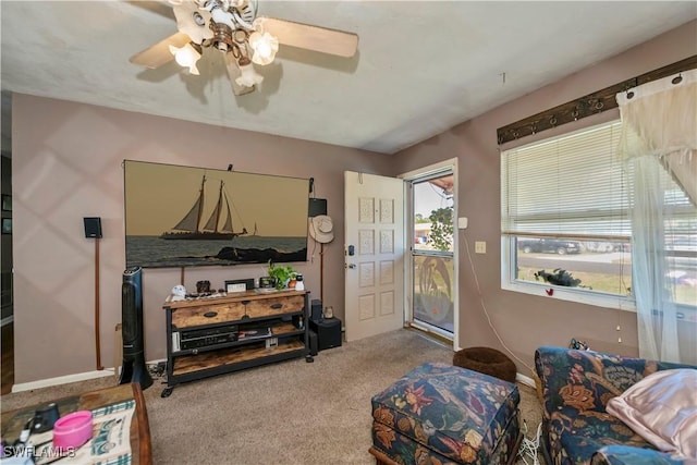 living room with carpet and a ceiling fan