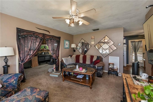 carpeted living area with ceiling fan and visible vents