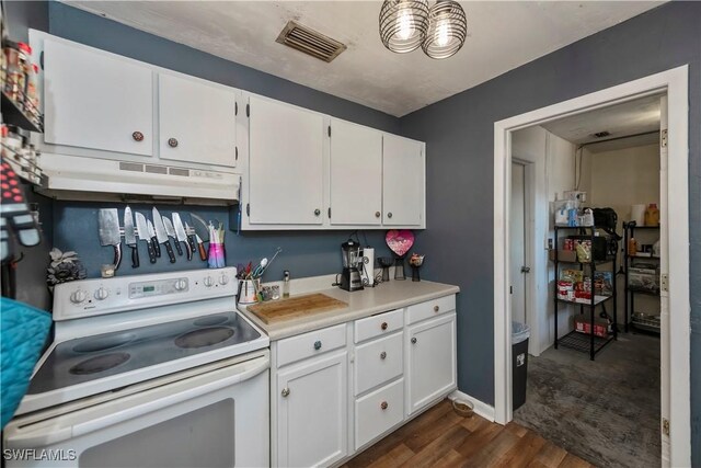 kitchen featuring white electric range oven, white cabinetry, under cabinet range hood, and visible vents