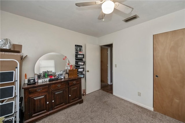 carpeted bedroom with a ceiling fan, visible vents, and baseboards