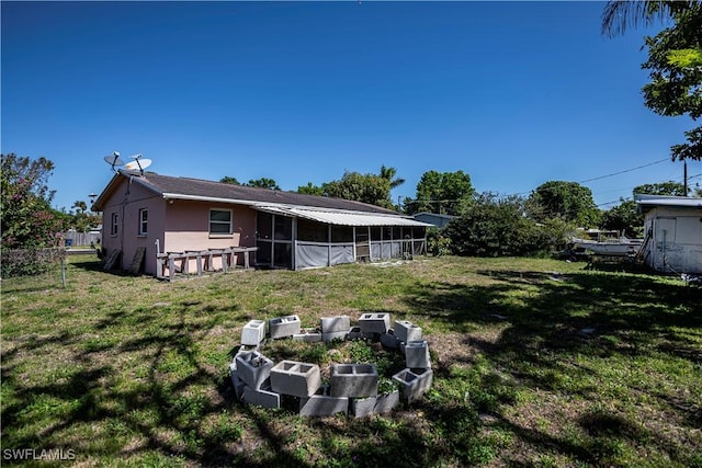 back of property with a yard and stucco siding