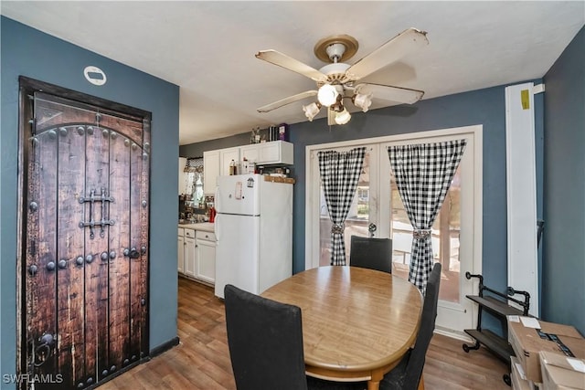 dining space featuring ceiling fan and wood finished floors