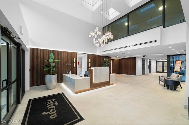 welcome area with a skylight and a chandelier