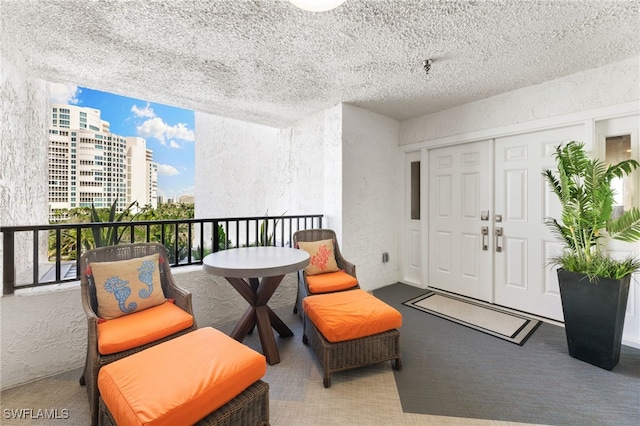 interior space featuring carpet flooring, a textured wall, and a textured ceiling