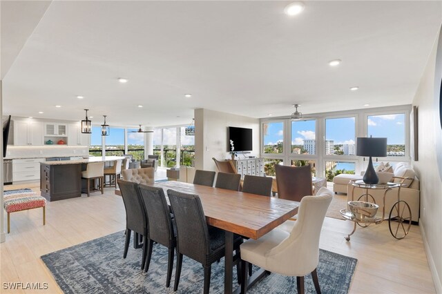 dining space featuring ceiling fan, light wood finished floors, and recessed lighting