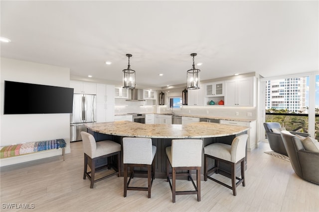 kitchen with a spacious island, tasteful backsplash, appliances with stainless steel finishes, glass insert cabinets, and white cabinetry