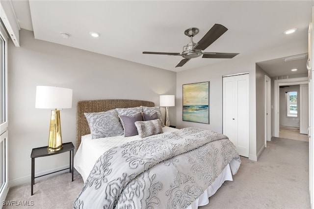 bedroom featuring recessed lighting, ceiling fan, a closet, and light colored carpet