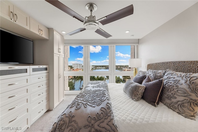 bedroom featuring light colored carpet and ceiling fan