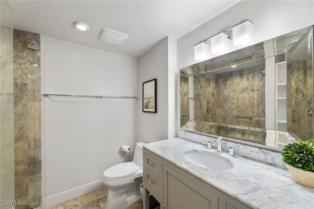 bathroom featuring a stall shower, vanity, and toilet