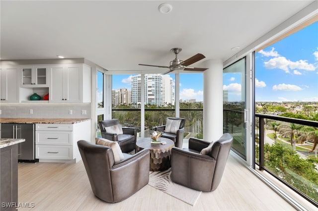 sunroom / solarium with a view of city and a ceiling fan