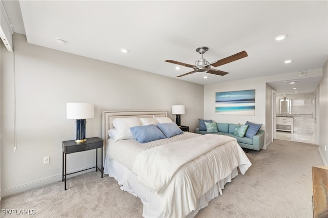 bedroom with ceiling fan, ensuite bathroom, recessed lighting, light carpet, and baseboards