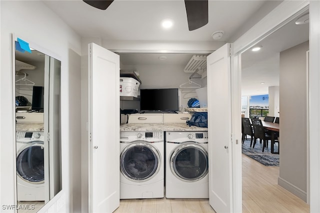 laundry area with laundry area, light wood-style floors, and washer and dryer