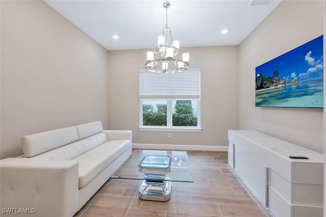 living room featuring wood finish floors, a notable chandelier, recessed lighting, visible vents, and baseboards