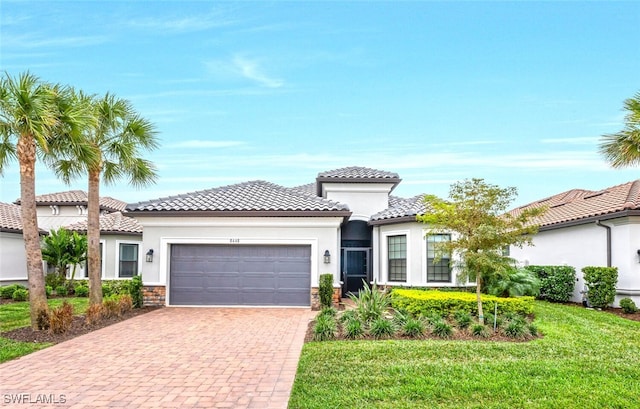 8448 Rosa Ct, Naples, FL 34114 - mediterranean / spanish-style home featuring a garage, stone siding, stucco siding, decorative driveway, and a front yard