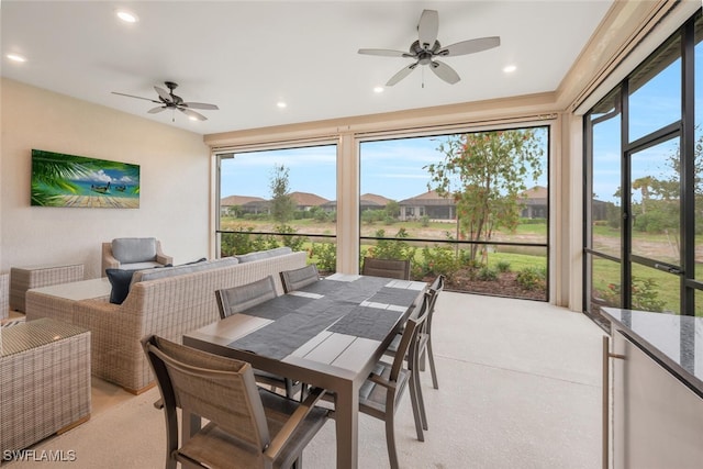 sunroom / solarium featuring ceiling fan and a healthy amount of sunlight