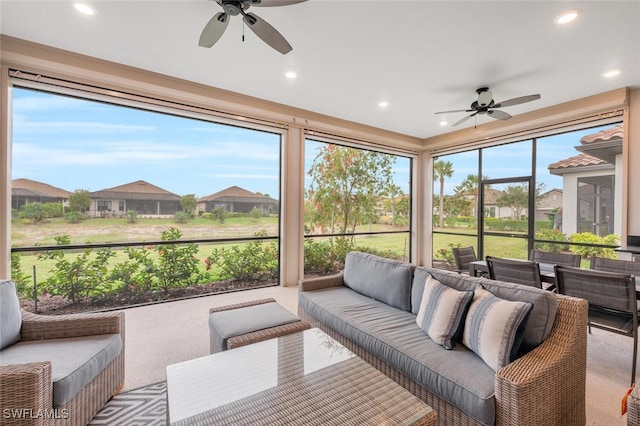 sunroom / solarium featuring a ceiling fan