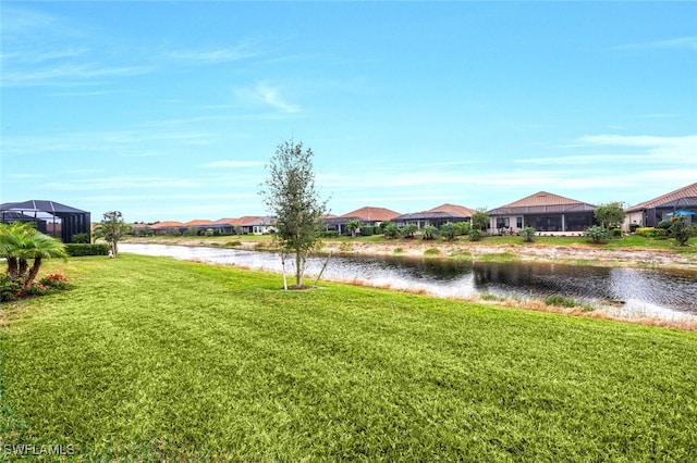 view of yard with a residential view and a water view