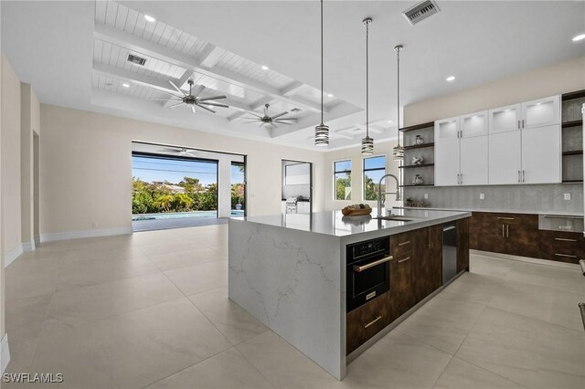 kitchen with open shelves, black oven, tasteful backsplash, and visible vents