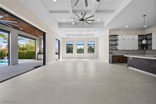 unfurnished living room featuring beam ceiling, recessed lighting, baseboards, and ceiling fan