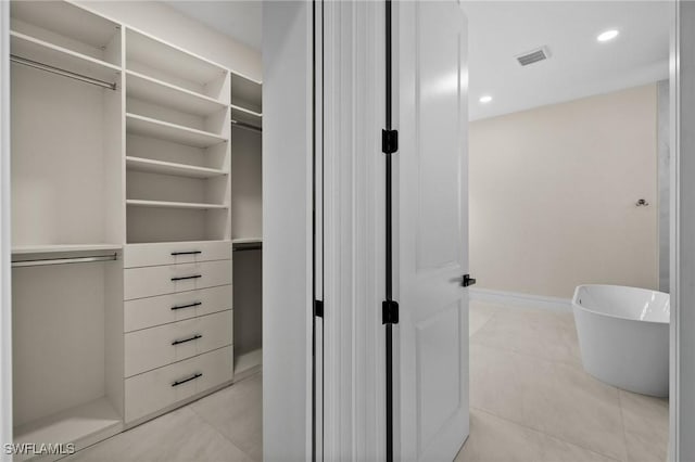 walk in closet featuring light tile patterned floors and visible vents