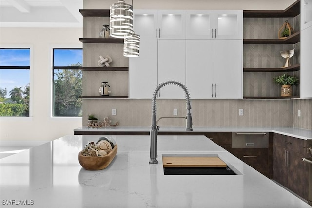 kitchen with tasteful backsplash, dark brown cabinets, and open shelves