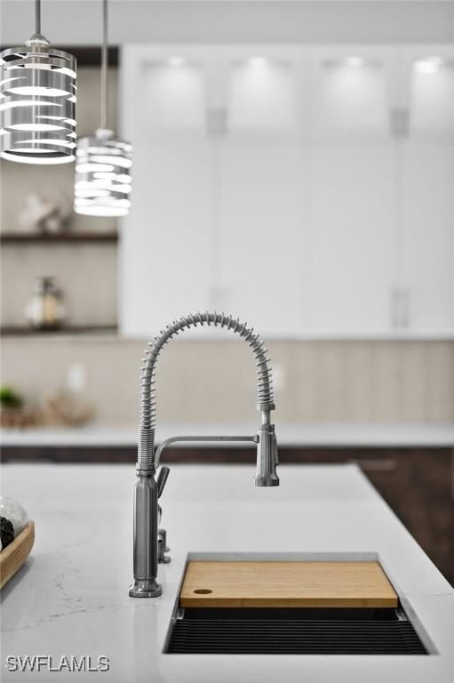 details featuring light countertops and a sink