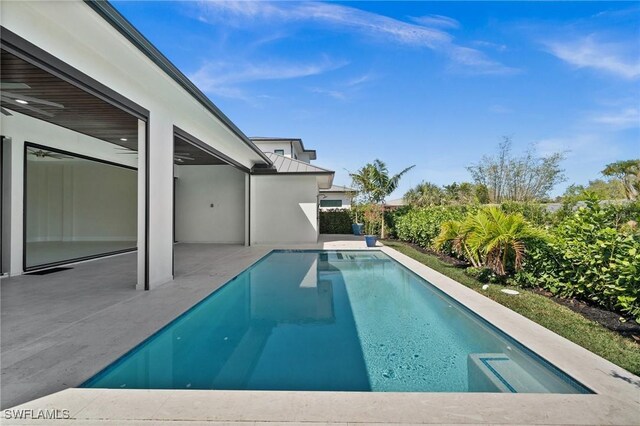 outdoor pool with a patio area