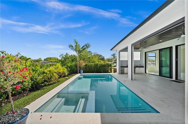 view of pool featuring a pool with connected hot tub, ceiling fan, and a patio area