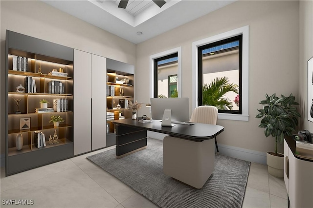 office area with light tile patterned floors, a ceiling fan, and baseboards
