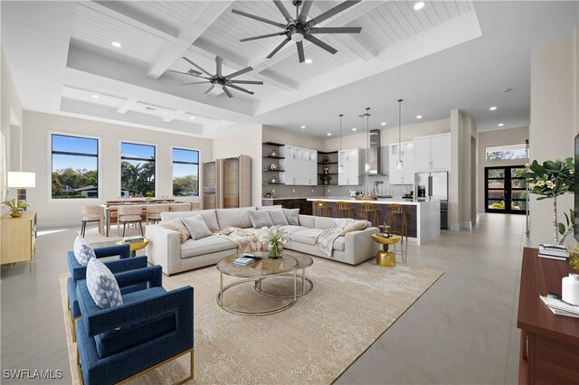 living room with baseboards, ceiling fan, beamed ceiling, recessed lighting, and coffered ceiling